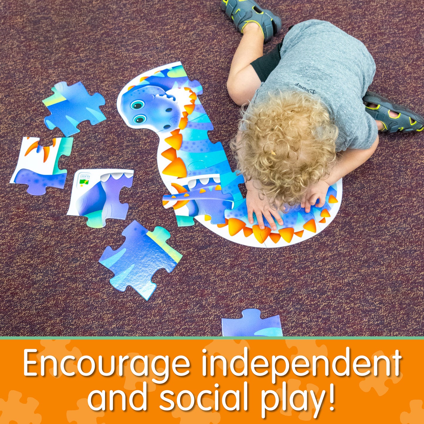 Infographic with little boy assembling My First Big Puzzle - Dinosaur that says, "Encourage independent and social play!"