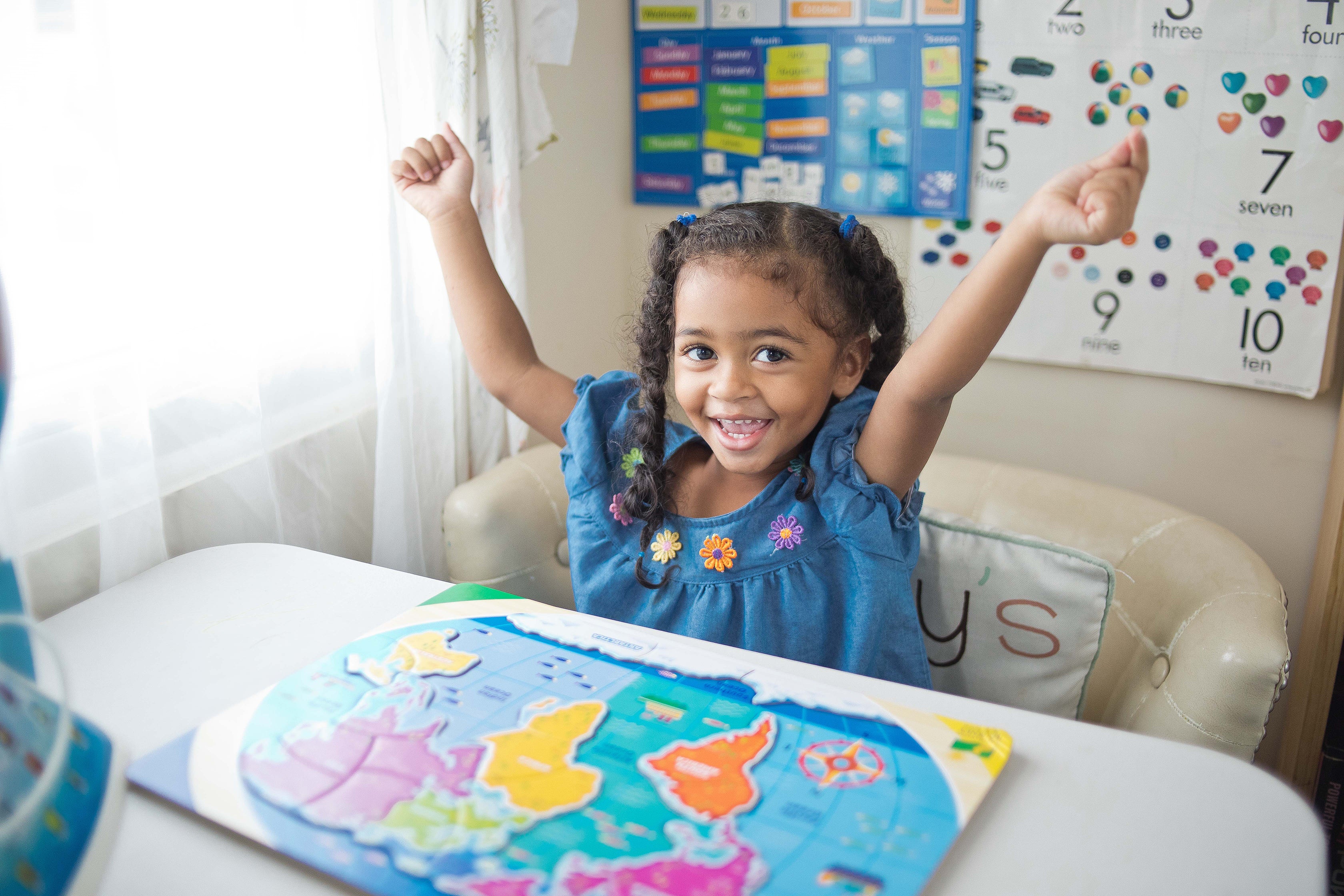young girl celebrating after completing puzzle
